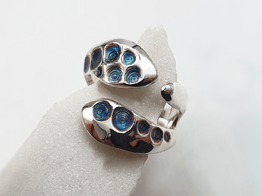 unique three-pronged silver ring with bioluminescent-style detail
