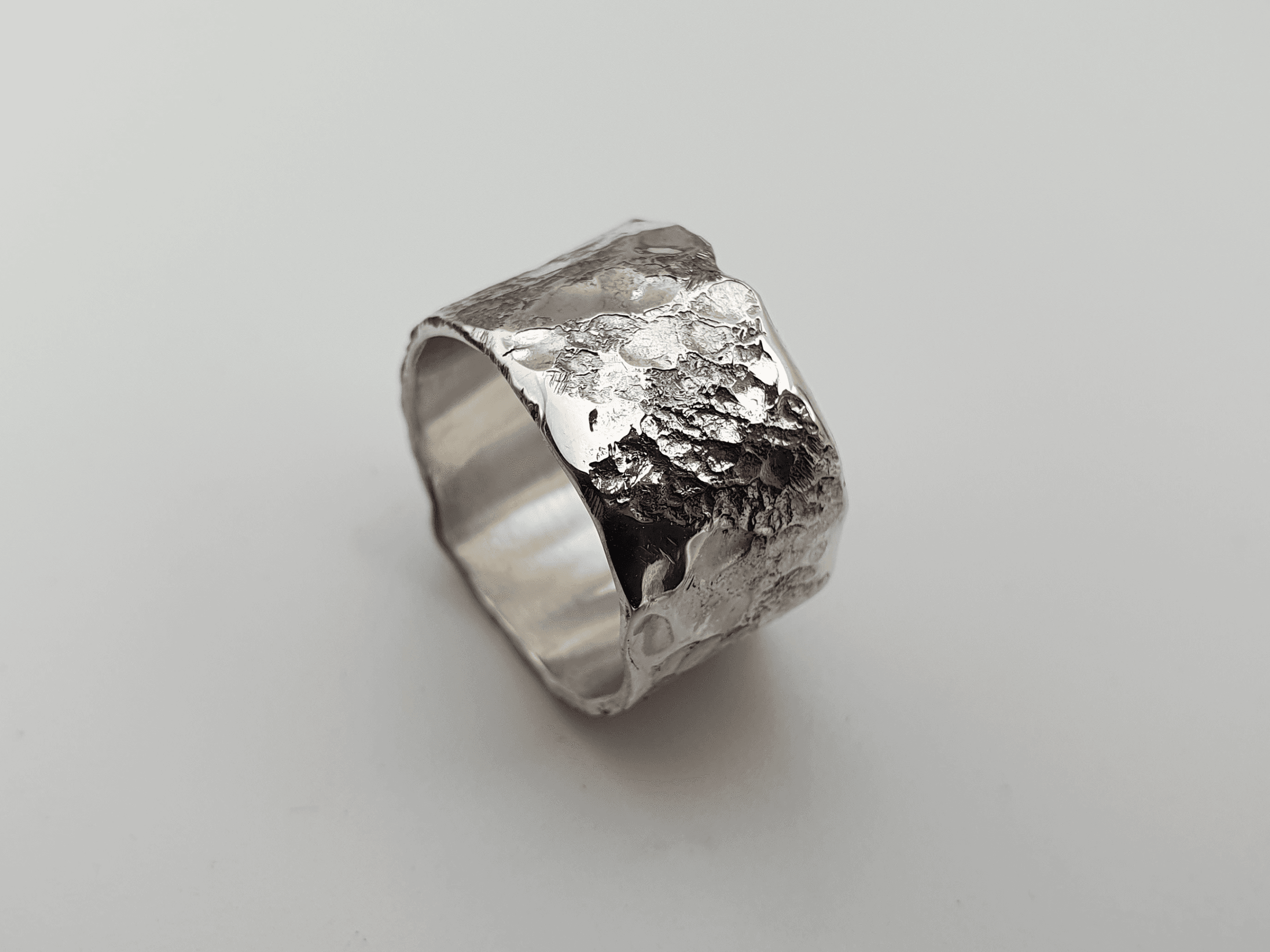 Eon Tether Ring, Cratered Silver Inspired by Timeworn Landscapes and Lasting Ties Eon Tether Ring, cratered silver inspired by timeworn landscapes and lasting ties
