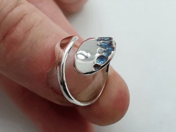 petalia-6 Iridescent alien petal-shaped textures catching light on silver ring