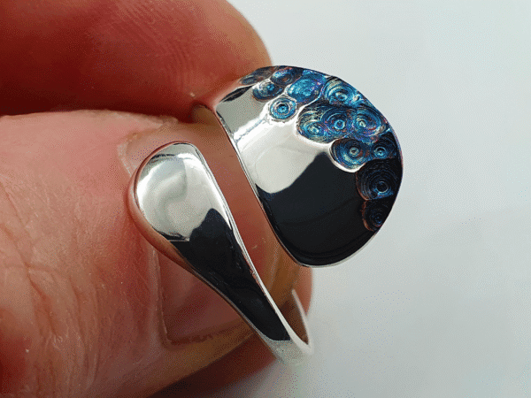 petalia-9 Close-up of Petalia ring showing iridescent spiral textures on one side