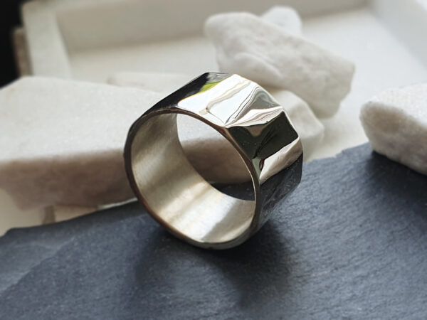 Prism ring angled view Three-quarter view of wide reflective silver prism ring